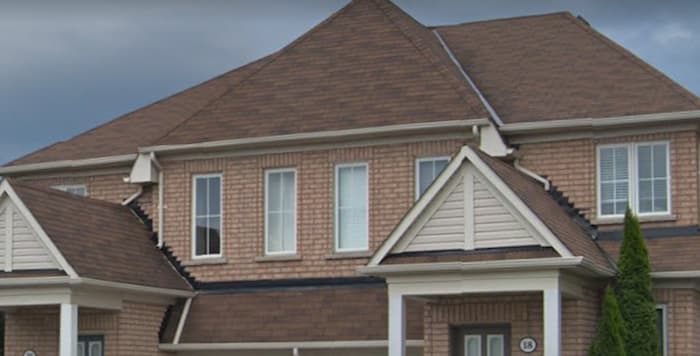 The redwood shingle we used matches the brick on this Uxbridge roofing replacement 