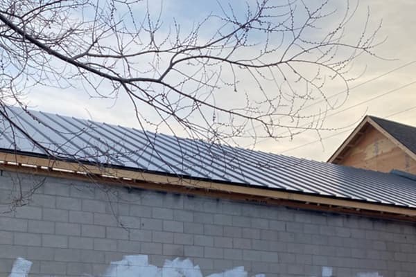 Behind the building you can see the completed job from our Oshawa roofers