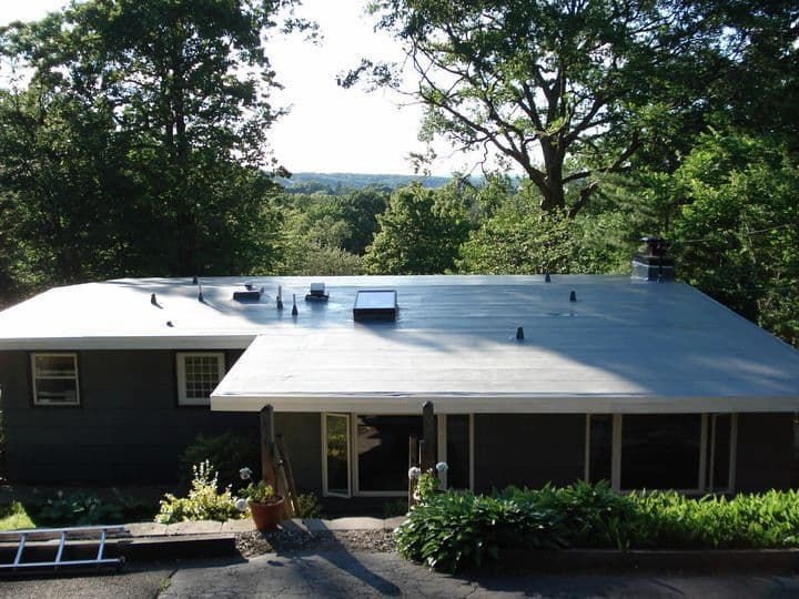 flat roof vs. shingle roof: this roof is showing the membrane
