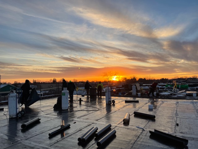 torch on flat roof at sunset