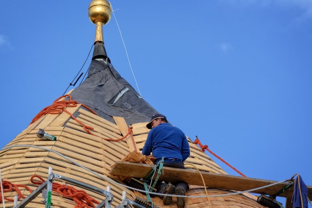 Roofer sitting on bench highest point on roof before winter