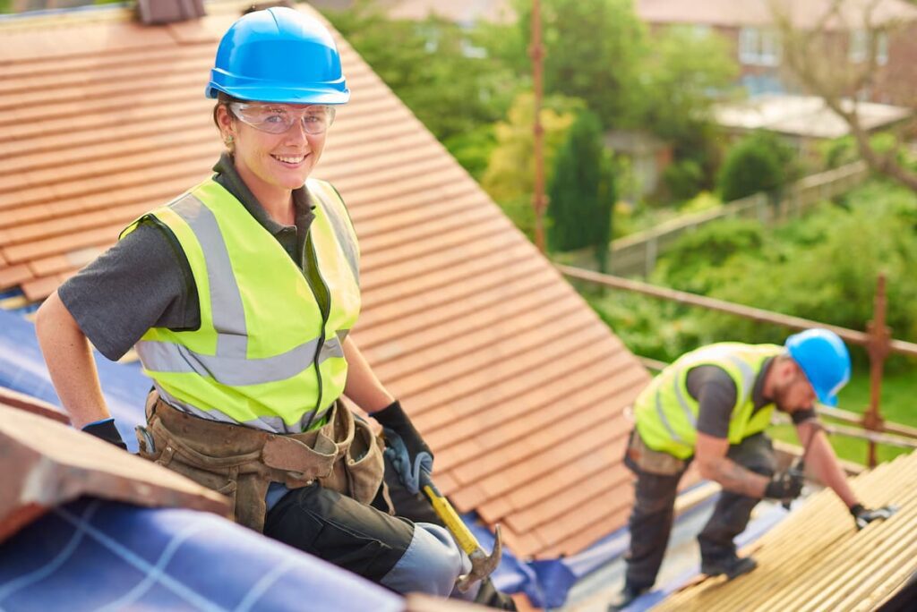 female roofer replacing a shingle roof