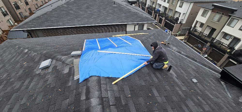 Emergency tarp secured with wood strapping over lightning strike damage — Pickering, ON — CD Roofing