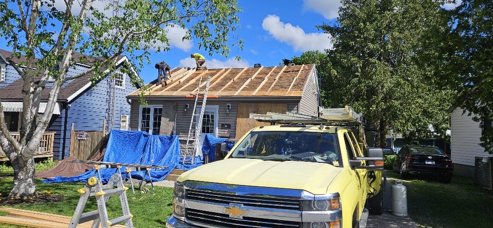 C.D. Roofing on site at an Ajax wartime home with tarps protecting the landscaping and a branded truck out front