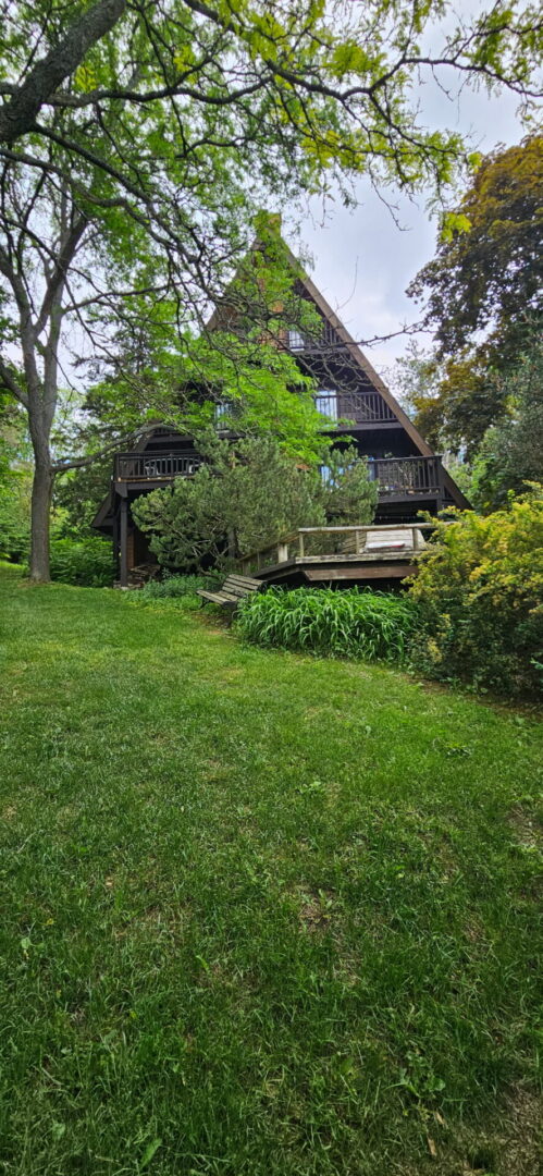 Steep A-frame cottage in Claremont, Ontario after a complete asphalt shingle roof replacement by C.D. Roofing