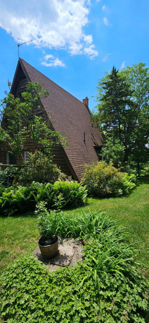 Completed cottage roof restoration with new shingles and skylights on a Claremont A-frame home, improving curb appeal