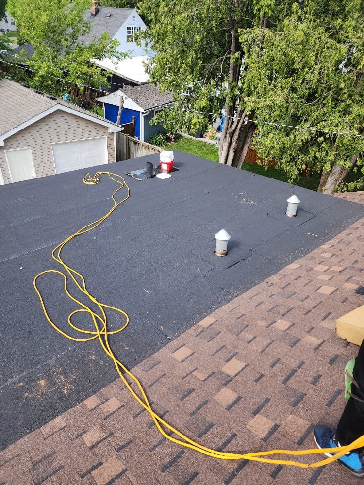 New torch-on modified bitumen flat roof at the rear of an Ajax wartime home, next to the new asphalt shingle roof