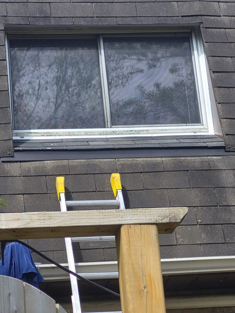 Roof window in Ajax after wood rot repair with new sheet metal flashing and new asphalt shingles by C.D. Roofing