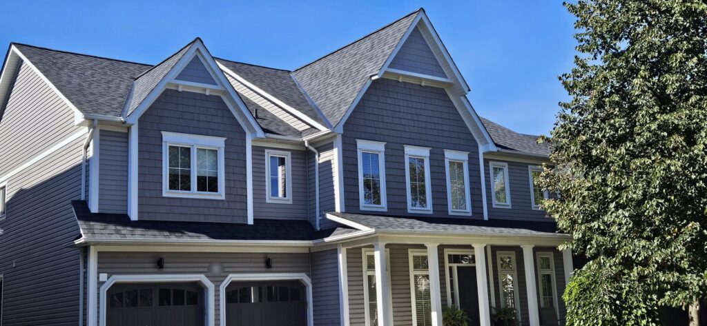 Close-up of BP Mystique 42 laminated shingles in 2-Tone Black on the front gables of a Brooklin home